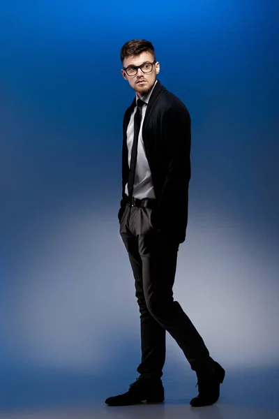 Retrato de joven guapo con gafas y camisa blanca sobre fondo azul — Foto de Stock