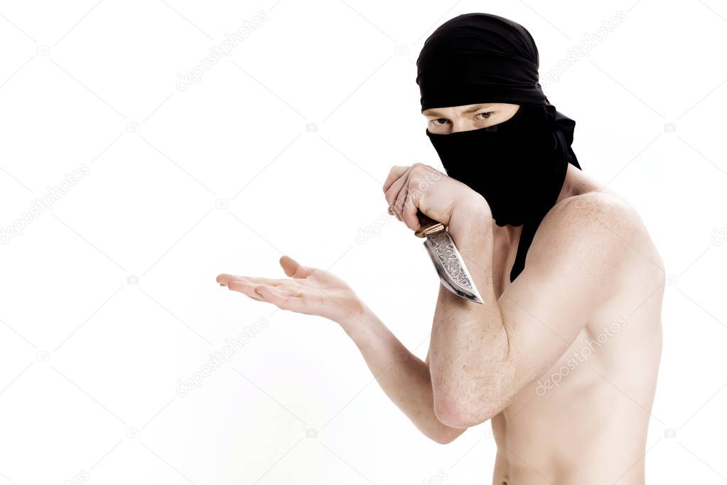 ninja man holds knife and is ready to attack on white background