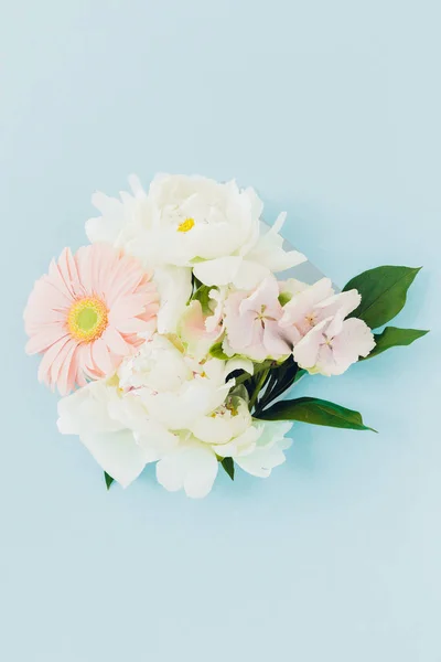 Strauß weißer und blauer Blumen im Rahmen auf blauem Hintergrund — Stockfoto