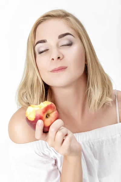 Hermosa mujer rubia con placer comiendo nectarina —  Fotos de Stock