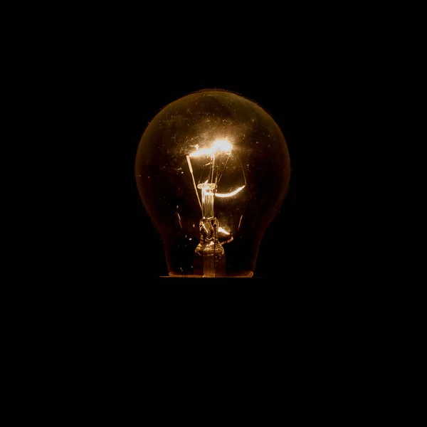 Light bulb on a black background — Stock Photo, Image