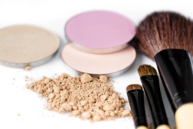 yüz, göz farı ve makyaj fırça beyaz zemin üzerine bej toz
