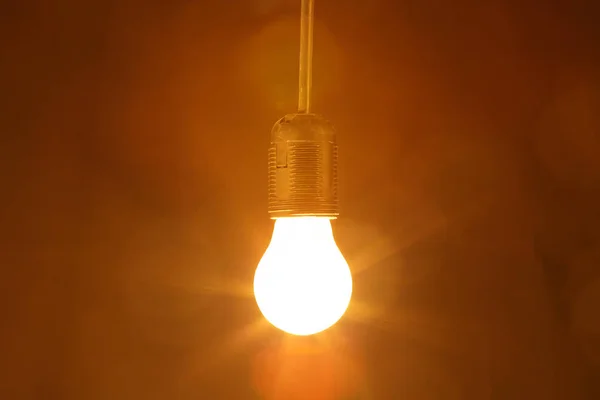 Light bulb on a black background — Stock Photo, Image