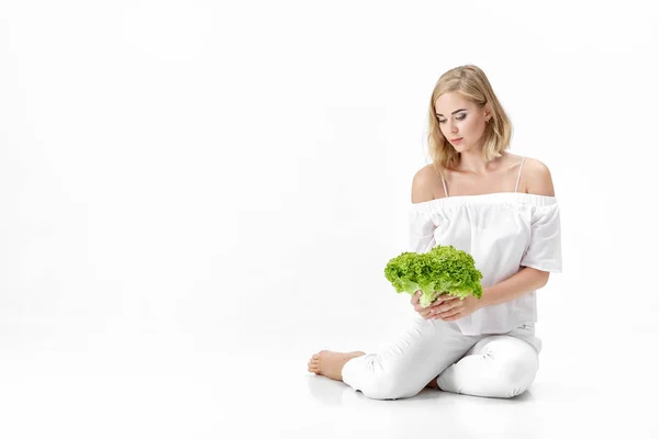 Beautiful blond woman in white blouse holding fresh green salad on white background. Health and Diet — Stock Photo, Image