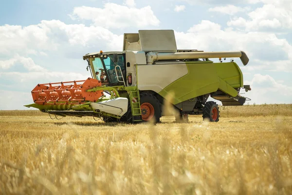 Werken combineren harvester in een tarweveld. Agrarische achtergrond. — Stockfoto