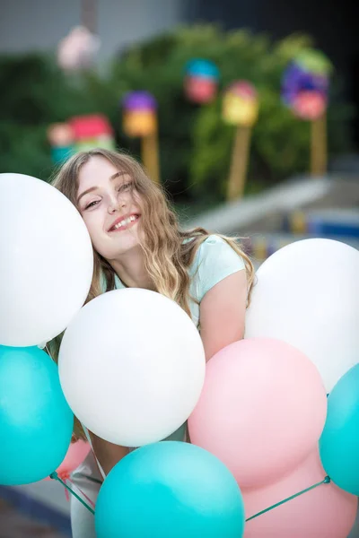 Hermosa mujer con vuelo multicolor globos — Foto de Stock