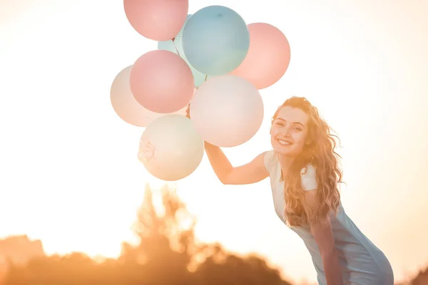 Belle femme avec des ballons multicolores volants — Photo