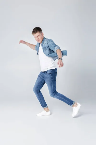 Bell'uomo in jeans e giacca saltando — Foto Stock