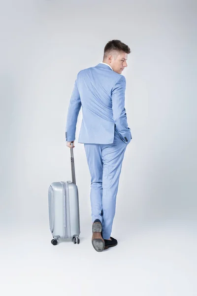 Ung man i blå kostym med resväska — Stockfoto