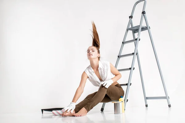 Vrouw in huis schilderen van een muur — Stockfoto