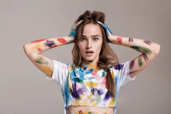 Young woman smeared in multicolored paint. — Stock Photo, Image