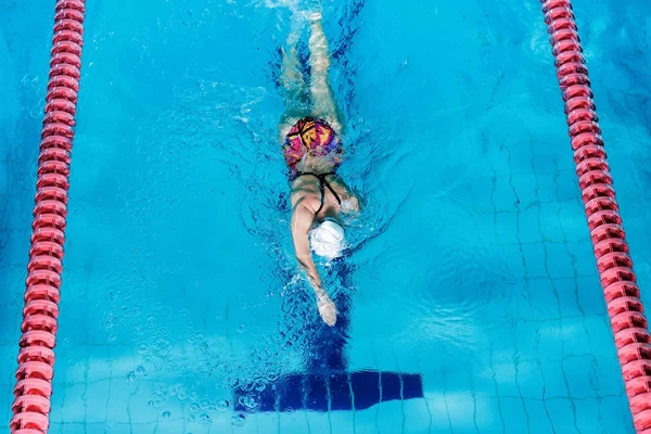 Kvinna som simma med simning hatt i poolen — Stockfoto