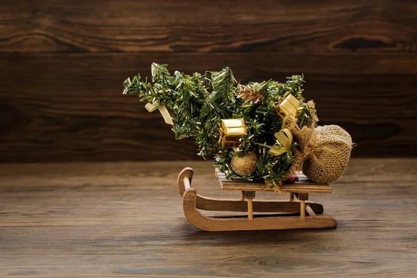 Fir-tree on sled on Christmas background — Stock Photo, Image