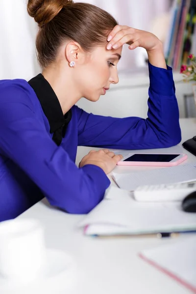 Tired woman manager in the office — Stock Photo, Image