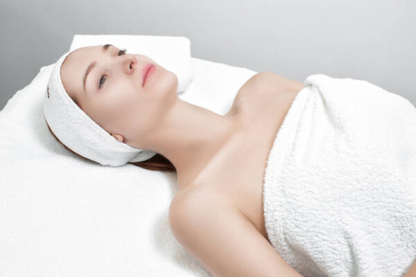 woman getting facial mask in spa