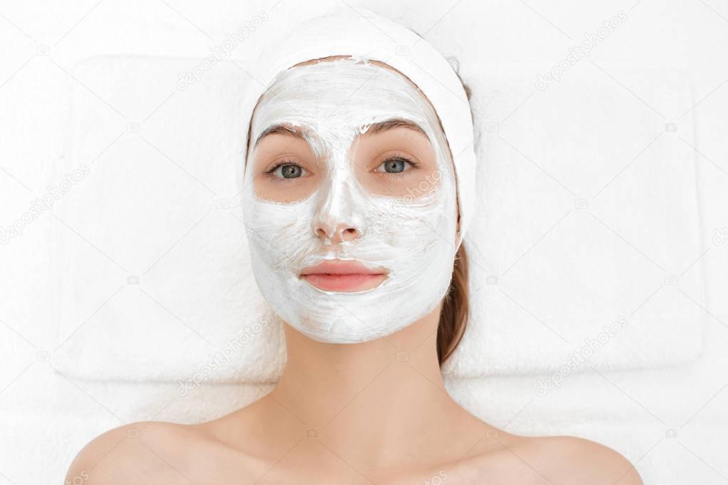 woman getting facial mask in spa