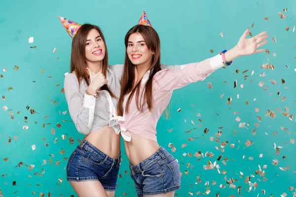 women in birthday hat and confetti on blue background.