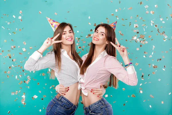 women in birthday hat and confetti on blue background.