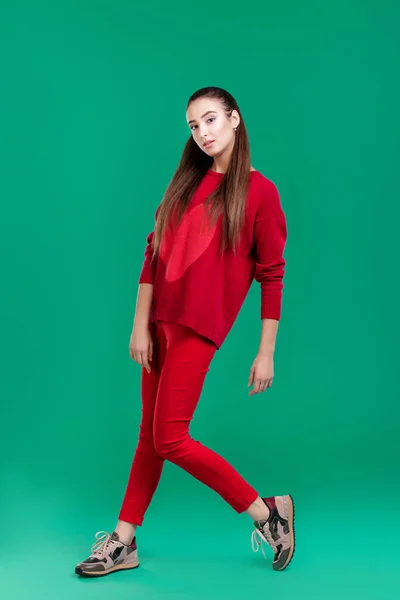 Woman in red sweater on green background — Stock Photo, Image