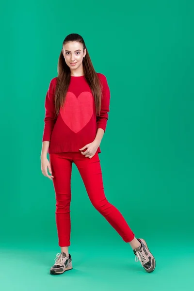 Woman in red sweater on green background — Stock Photo, Image