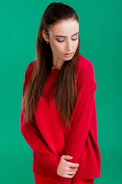 Woman in red sweater on green background — Stock Photo, Image