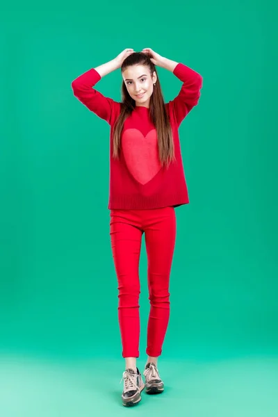 Woman in red sweater on green background — Stock Photo, Image