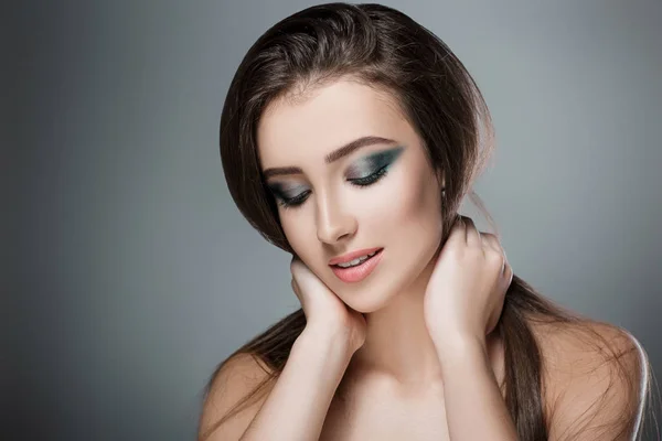 Beautiful woman with green evening make-up — Stock Photo, Image