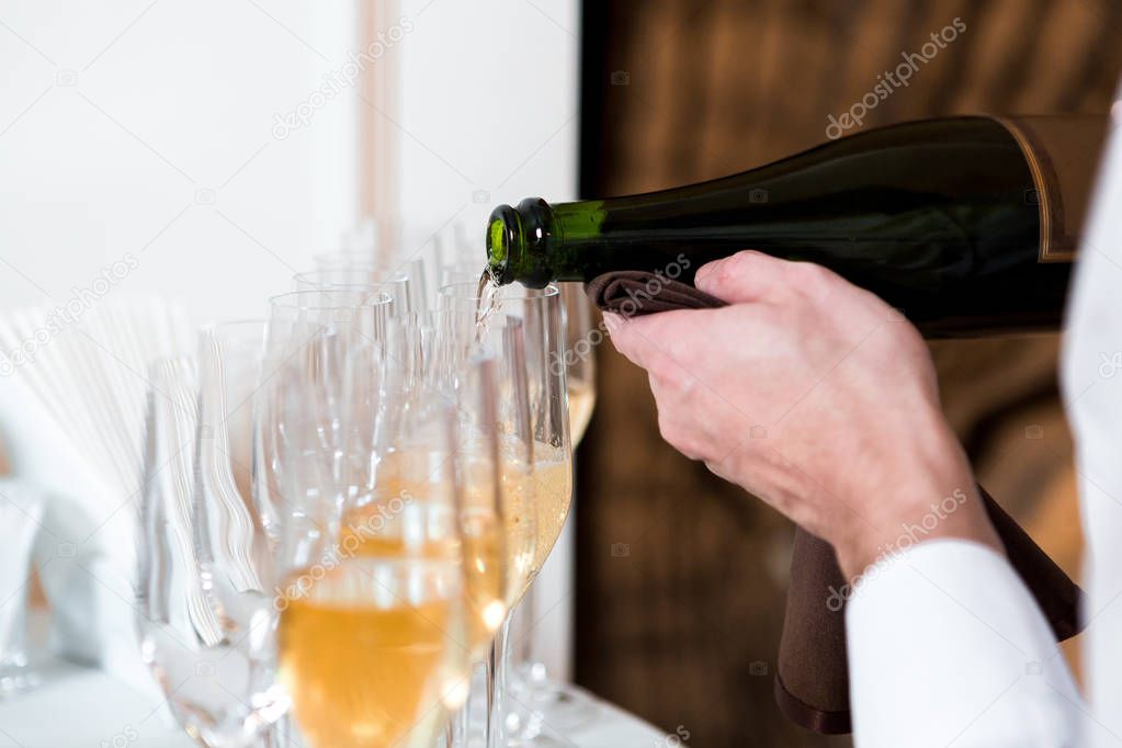 waiter pours champagne