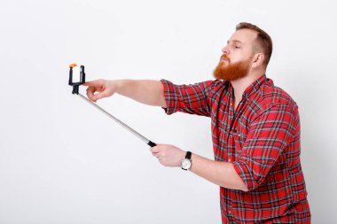 adam selfie telefona yapar.