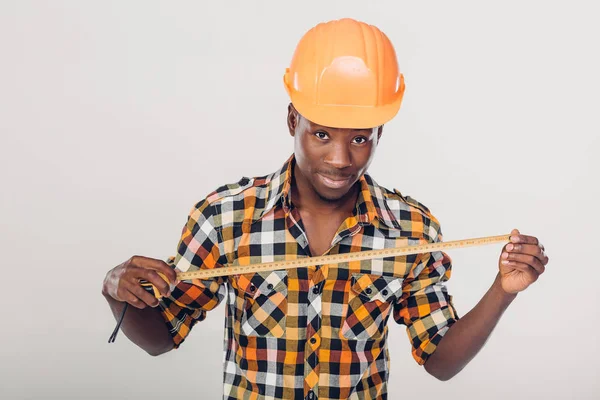 Afro-Amerikaanse builder gebruikt meetlint — Stockfoto