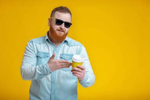 red beard man holding cup with coffee