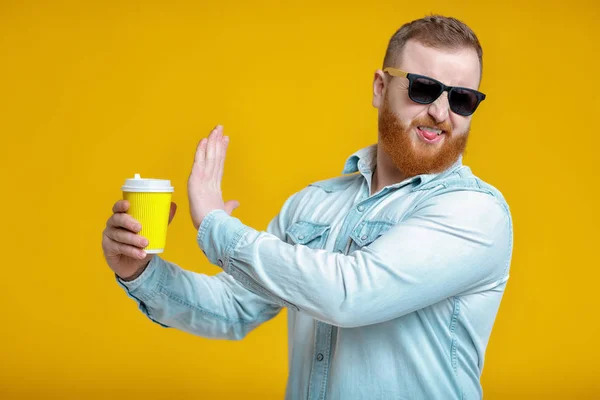 red beard man holding cup with coffee