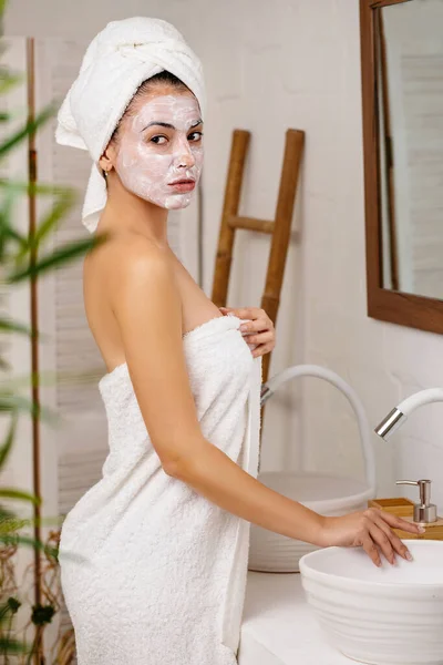 Woman is applying mask on her face — Stock Photo, Image