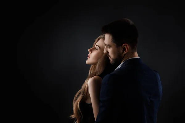 Elegant couple on black background. — Stock Photo, Image