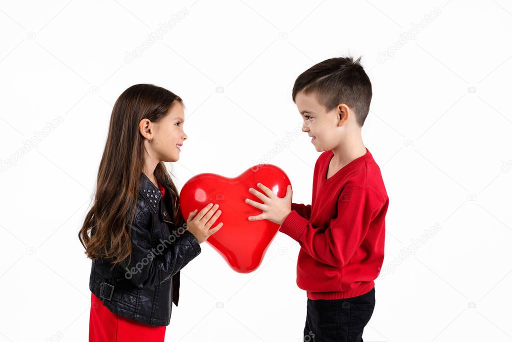 Happy kids with red heart balloon