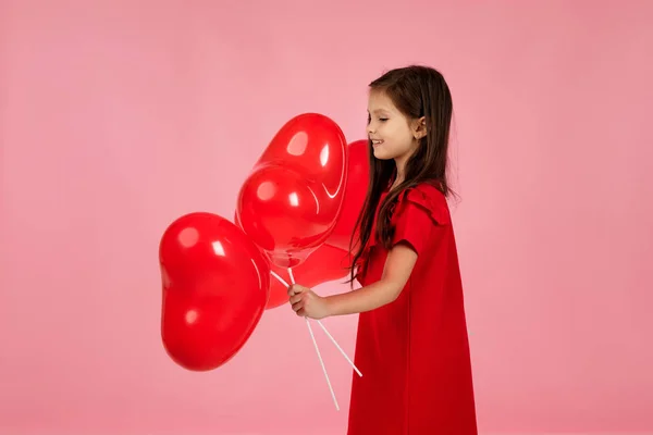 Дитяча дівчина тримає червону кульку у формі серця — стокове фото