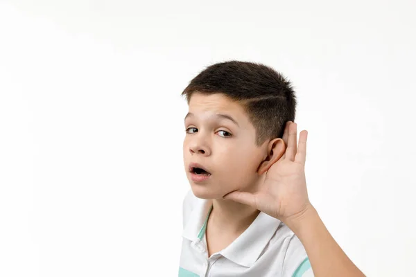Child boy in striped t-shirt making hearing gesture — Stock Photo, Image
