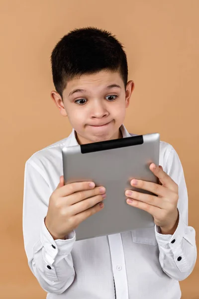 Little surprised boy using tablet — ストック写真