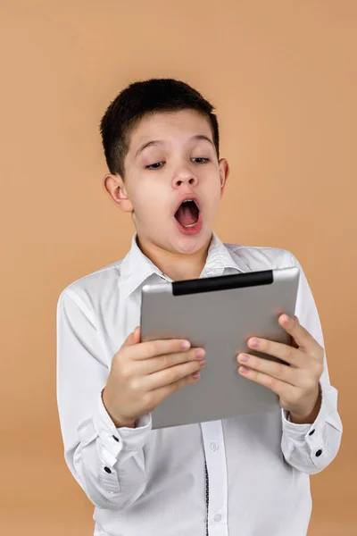 Pequeño chico sorprendido usando tableta —  Fotos de Stock