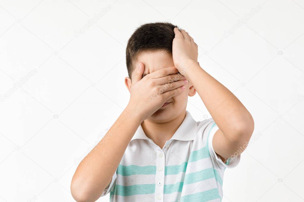 sad little child boy in striped t-shirt