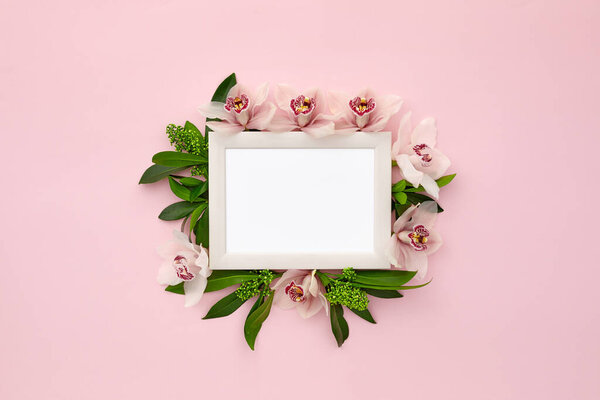 photo frame decorated with green leaves and orchid flowers