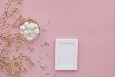 düz çiçekler, pembe arkaplanda fotoğraf çerçevesi