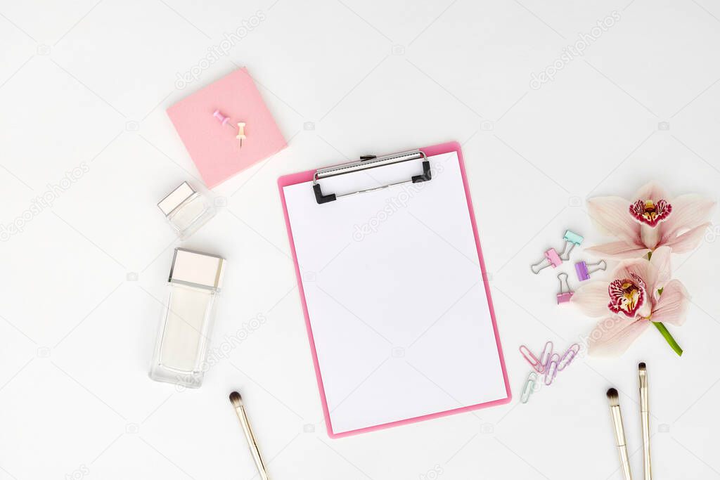 Mockup with clipboard, orchid flowers and clips