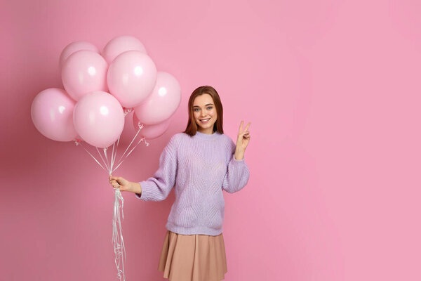 birthday girl posing with balloons