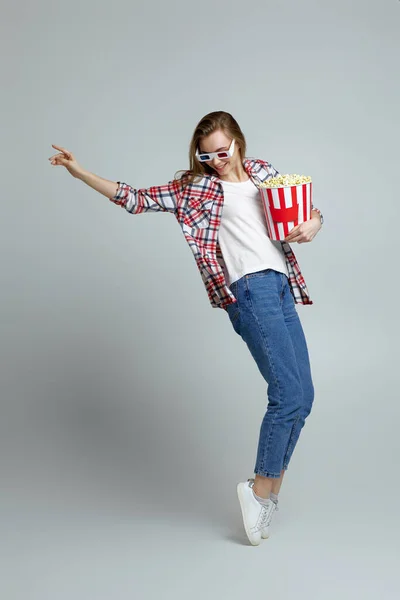 Женщина в красно-синих 3d очках держа ведро с попкорном — стоковое фото