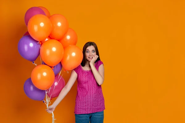 Mujer tímida y avergonzada con brillantes globos de aire de colores — Foto de Stock