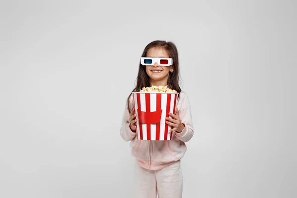 Девочка в красно-синих 3d очках и ест попкорн — стоковое фото