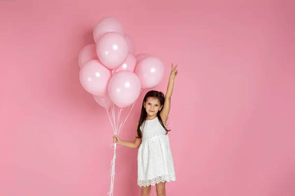 Adorable little child girl with pastel pink air balloons — Stock Photo, Image
