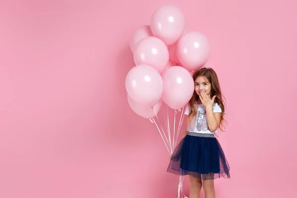 Kind meisje poseren met pastel roze lucht ballonnen — Stockfoto