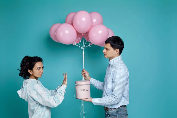 Hombre presentando globos de aire rosa a novia sobre fondo azul — Foto de Stock